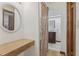 Hallway vanity and bathroom access, featuring a barn door and a decorative mirror for a touch of elegance at 1221 Candlelight Blvd, Brooksville, FL 34601
