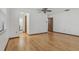 Bright bedroom with hardwood floors, a ceiling fan, and access to an en-suite bathroom, creating a private retreat at 1221 Candlelight Blvd, Brooksville, FL 34601