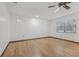 Bright bedroom with hardwood floors, a ceiling fan, and large windows offering natural light and ventilation at 1221 Candlelight Blvd, Brooksville, FL 34601