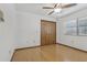 Bedroom with wood floors, ceiling fan, window with blinds and closet at 1221 Candlelight Blvd, Brooksville, FL 34601