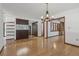 Hardwood dining room featuring bar seating and opening to the kitchen at 1221 Candlelight Blvd, Brooksville, FL 34601