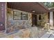 Inviting entryway with stone accents, dark brown door, and covered porch at 1221 Candlelight Blvd, Brooksville, FL 34601