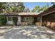 Charming single-story home featuring a stone facade, brown trim, and a spacious driveway at 1221 Candlelight Blvd, Brooksville, FL 34601