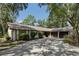Charming ranch-style home with a two-car garage and a long driveway, surrounded by mature shade trees at 1221 Candlelight Blvd, Brooksville, FL 34601