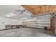 Spacious garage features built-in wooden shelves and a work bench, with ample storage and work space at 1221 Candlelight Blvd, Brooksville, FL 34601