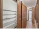 Hallway closet with custom shelving and rustic sliding barn doors at 1221 Candlelight Blvd, Brooksville, FL 34601