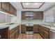 Kitchen view, featuring stainless appliances and abundant wooden cabinetry at 1221 Candlelight Blvd, Brooksville, FL 34601