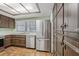 Kitchen showcasing stainless steel appliances, plentiful cabinets, and tiled floor at 1221 Candlelight Blvd, Brooksville, FL 34601