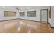 Spacious living room with hardwood floors, natural light, and a ceiling fan at 1221 Candlelight Blvd, Brooksville, FL 34601