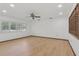 Bright, spacious living room featuring hardwood floors and a ceiling fan, ready for relaxation and entertaining at 1221 Candlelight Blvd, Brooksville, FL 34601
