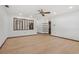 Open-concept living room features hardwood floors, a ceiling fan, and views into other areas of the home at 1221 Candlelight Blvd, Brooksville, FL 34601