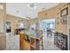 An indoor wooden bar with chairs and wine storage in a neutral color palette at 1410 Monte Lake Dr, Valrico, FL 33596