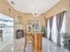 An indoor wooden bar with chairs and barware storage in a neutral color palette at 1410 Monte Lake Dr, Valrico, FL 33596