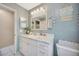 Bright bathroom with a marble countertop, white cabinets, and nautical decor, creating a serene, coastal-inspired retreat at 1410 Monte Lake Dr, Valrico, FL 33596
