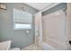 Neutral bathroom showcasing a shower over the tub and a window, offering a bright and functional space at 1410 Monte Lake Dr, Valrico, FL 33596