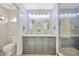 Bathroom featuring a double vanity with a marble top and decorative lighting at 1410 Monte Lake Dr, Valrico, FL 33596