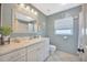 Bathroom featuring a white vanity with a marble top, decorative accents, and a window at 1410 Monte Lake Dr, Valrico, FL 33596