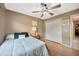 Bedroom with closet doors, ceiling fan, and a window highlighting cozy living and natural light at 1410 Monte Lake Dr, Valrico, FL 33596