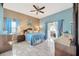 The main bedroom has blue and beige walls and includes a ceiling fan, lamps, and outdoor access at 1410 Monte Lake Dr, Valrico, FL 33596