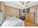 Bedroom featuring wood laminate floors, ceiling fan, and sports decor at 1410 Monte Lake Dr, Valrico, FL 33596