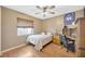 Bedroom featuring wood laminate floors, ceiling fan, and window with blind at 1410 Monte Lake Dr, Valrico, FL 33596