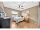 Cozy bedroom with a ceiling fan, light-toned walls and wood floors offering a comfortable private retreat at 1410 Monte Lake Dr, Valrico, FL 33596