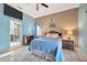 The main bedroom features beige and blue walls, with a ceiling fan and a bathroom down the hall at 1410 Monte Lake Dr, Valrico, FL 33596