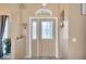 Bright foyer with a decorative glass front door and neutral wall color at 1410 Monte Lake Dr, Valrico, FL 33596