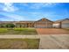 Charming single-story home featuring a three-car garage and beautifully manicured lawn at 1410 Monte Lake Dr, Valrico, FL 33596