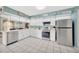 A kitchen with white cabinetry, stainless steel appliances and tile flooring at 1410 Monte Lake Dr, Valrico, FL 33596