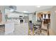 A kitchen featuring white cabinetry, stainless appliances, and an adjacent dining area at 1410 Monte Lake Dr, Valrico, FL 33596