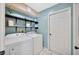Functional laundry area equipped with washer, dryer, shelving, and blue walls enhancing efficiency and appeal at 1410 Monte Lake Dr, Valrico, FL 33596