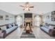 This open living room has a brick fireplace with a flat screen TV and two couches facing each other at 1410 Monte Lake Dr, Valrico, FL 33596