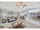 The living room features a ceiling fan and open access to the kitchen, with bar-stool seating available at 1410 Monte Lake Dr, Valrico, FL 33596