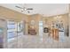 Bright living area boasts tile floors, a ceiling fan and a sliding glass door to the pool at 1410 Monte Lake Dr, Valrico, FL 33596