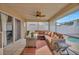 Enclosed patio with a fan, wicker furniture, and sliding glass doors, offering a relaxing indoor-outdoor lifestyle at 1410 Monte Lake Dr, Valrico, FL 33596