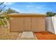 Backyard utility shed with a metal roof, offering practical outdoor storage at 1410 Monte Lake Dr, Valrico, FL 33596