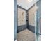 Close up of shower with mosaic tile floor, decorative tile, and glass door at 1410 Monte Lake Dr, Valrico, FL 33596