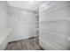 Spacious walk-in closet with wire shelving and laminate floors at 1410 Monte Lake Dr, Valrico, FL 33596