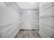 Walk-in closet with wire shelving and laminate floors at 1410 Monte Lake Dr, Valrico, FL 33596