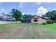 Spacious backyard featuring a screened-in patio and lush greenery at 15302 Lake Maurine Dr, Odessa, FL 33556