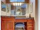 Bathroom features a vanity with a makeup area, ample storage, and an oversized mirror at 15302 Lake Maurine Dr, Odessa, FL 33556