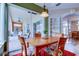 Cozy dining area with a wooden table, decorative chairs, and view of the screened lanai at 15302 Lake Maurine Dr, Odessa, FL 33556