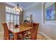 Elegant dining room with natural light, classic chandelier, and seating for six at 15302 Lake Maurine Dr, Odessa, FL 33556