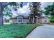 Charming single-story home featuring a well-manicured lawn and an inviting front entrance at 15302 Lake Maurine Dr, Odessa, FL 33556
