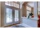 Elegant foyer featuring tile flooring, decorative glass doors, and a transom window for ample natural light at 15302 Lake Maurine Dr, Odessa, FL 33556