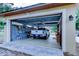 Three-car garage with a vehicle parked inside showcasing the high ceilings and available storage space at 15302 Lake Maurine Dr, Odessa, FL 33556