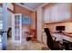 Bright home office with built-in desk, storage, and a view to the outdoors at 15302 Lake Maurine Dr, Odessa, FL 33556