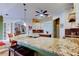 Open kitchen featuring a large island with seating, granite countertops, and modern appliances at 15302 Lake Maurine Dr, Odessa, FL 33556