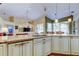 Bright kitchen with granite countertops, custom cabinetry, and open layout to Gathering area at 15302 Lake Maurine Dr, Odessa, FL 33556